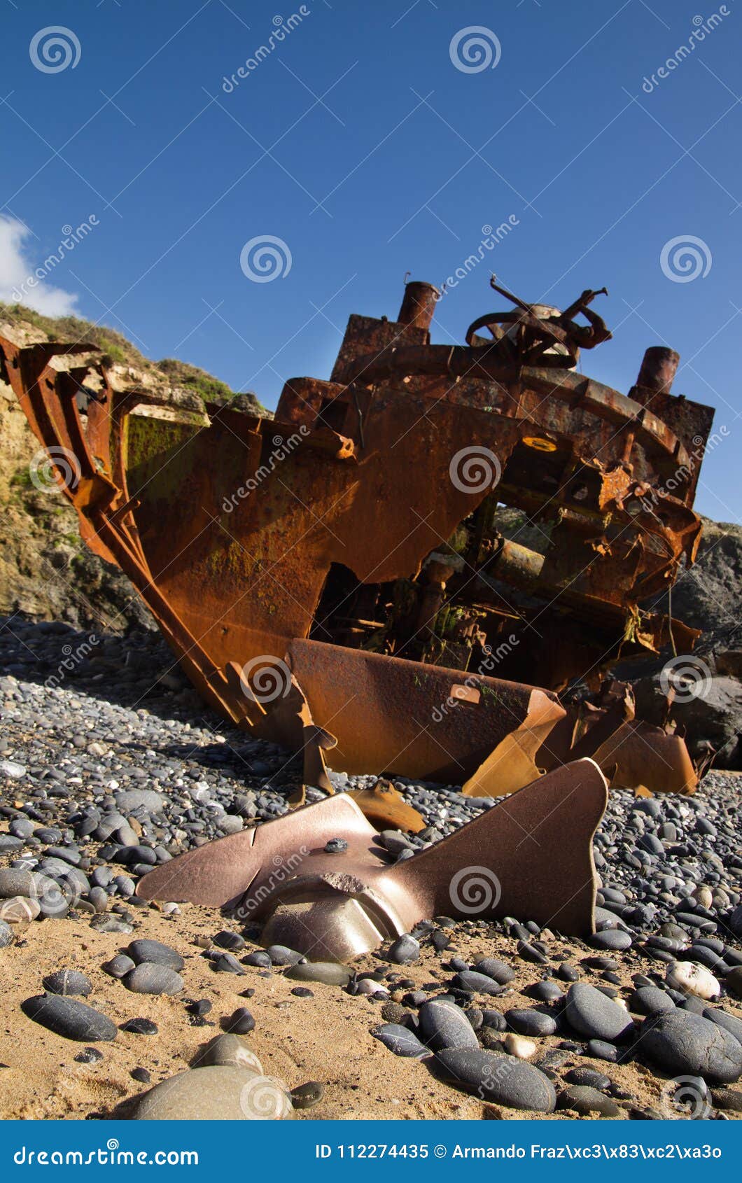 withered and half buried propeller of a wrecked pusher boat
