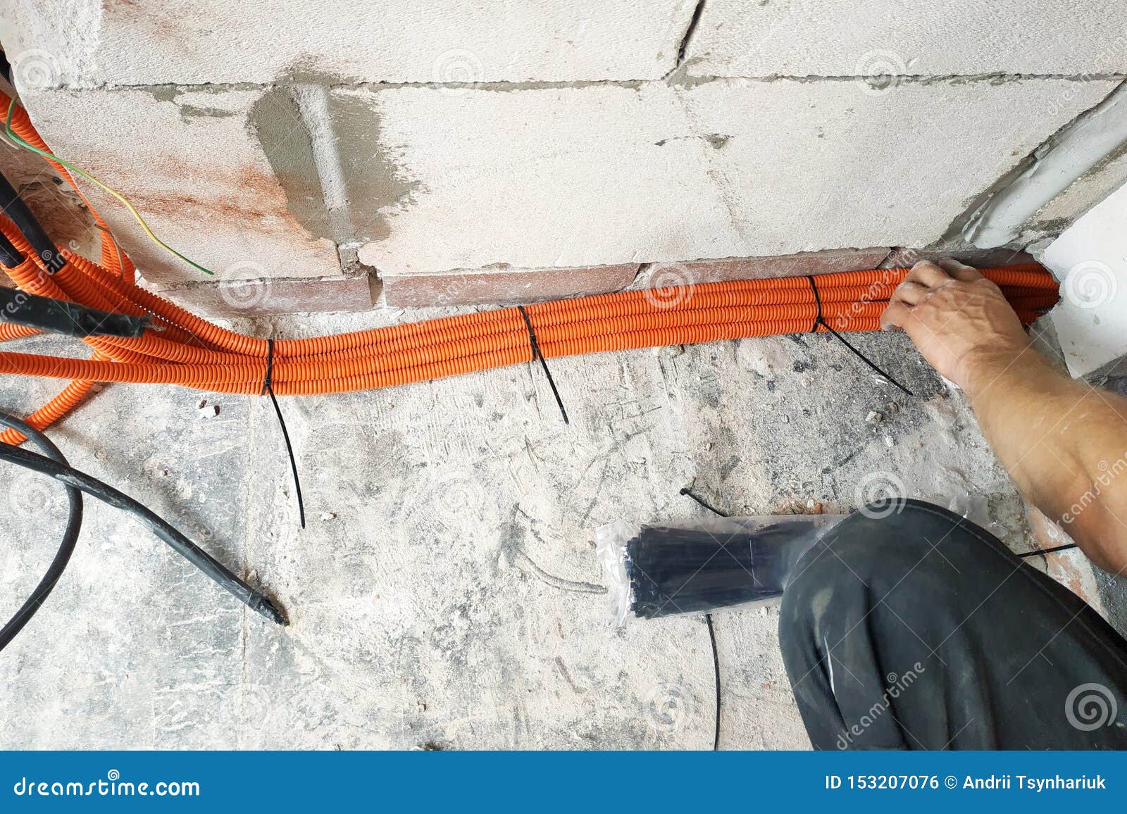 The Wizard Performs the Laying of Electrical Cables To the Electric