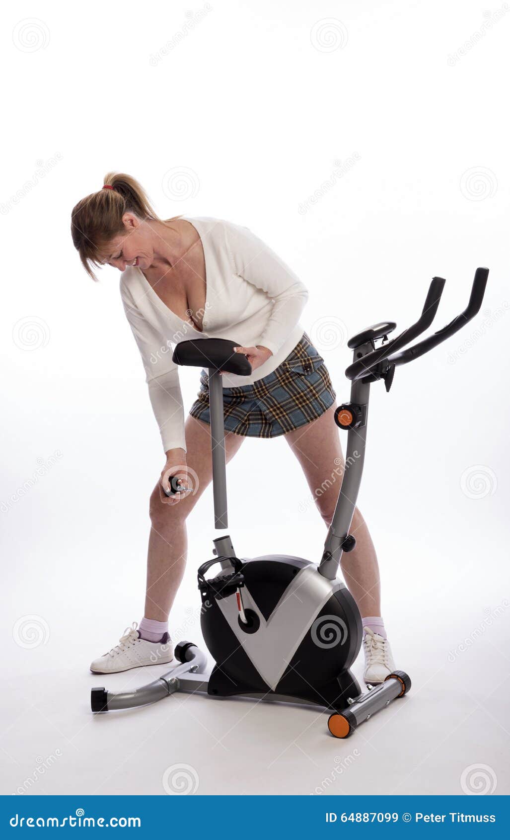 Woman Adjusts Saddle on Exercise Bike Stock Image Image of body