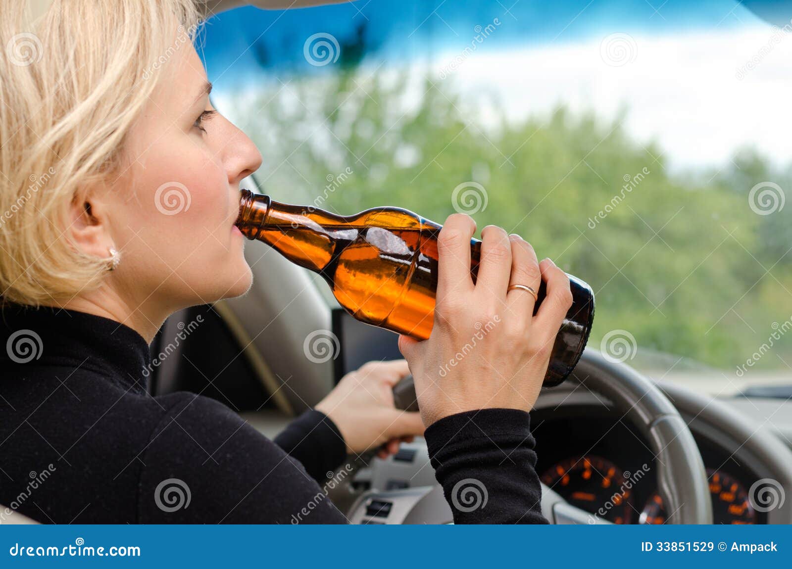 Photo about Close up view from behind of a woman alcoholic drinking from a ...