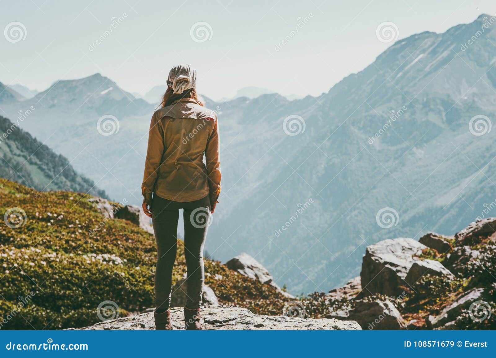 woman alone standing in mountains wander landscape