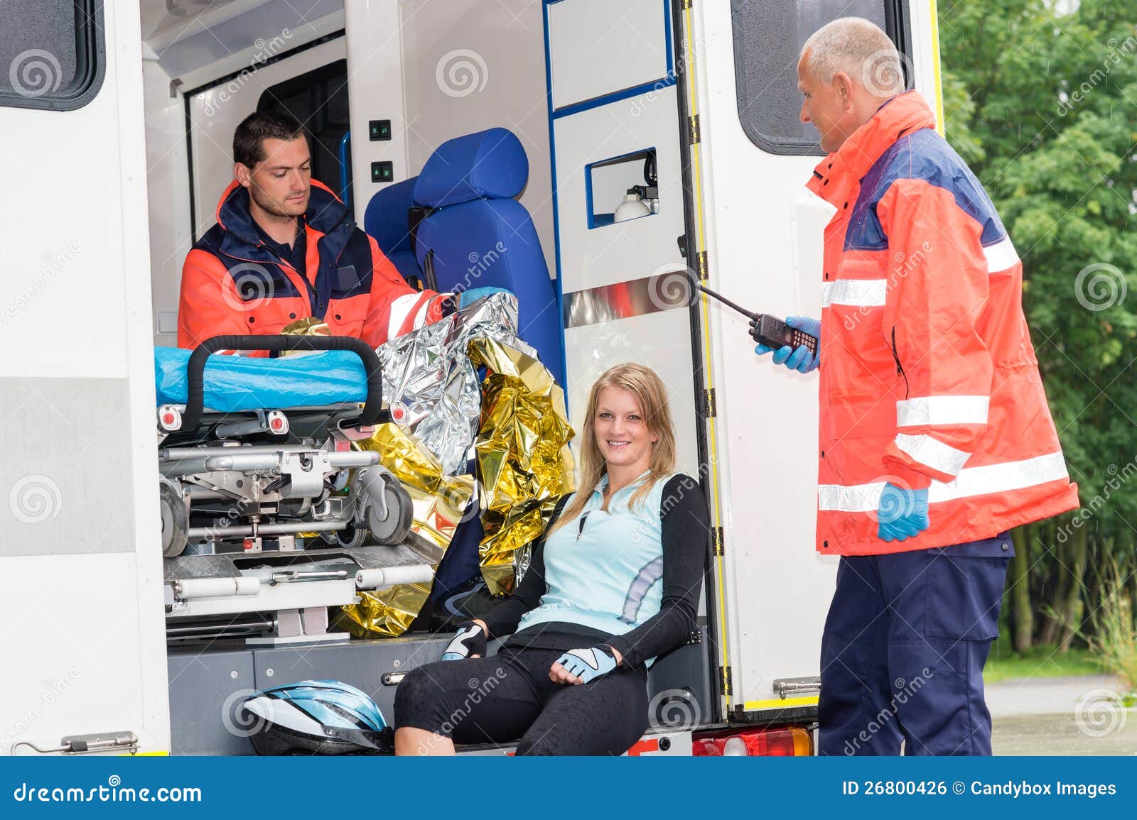 woman in ambulance with paramedics aid accident