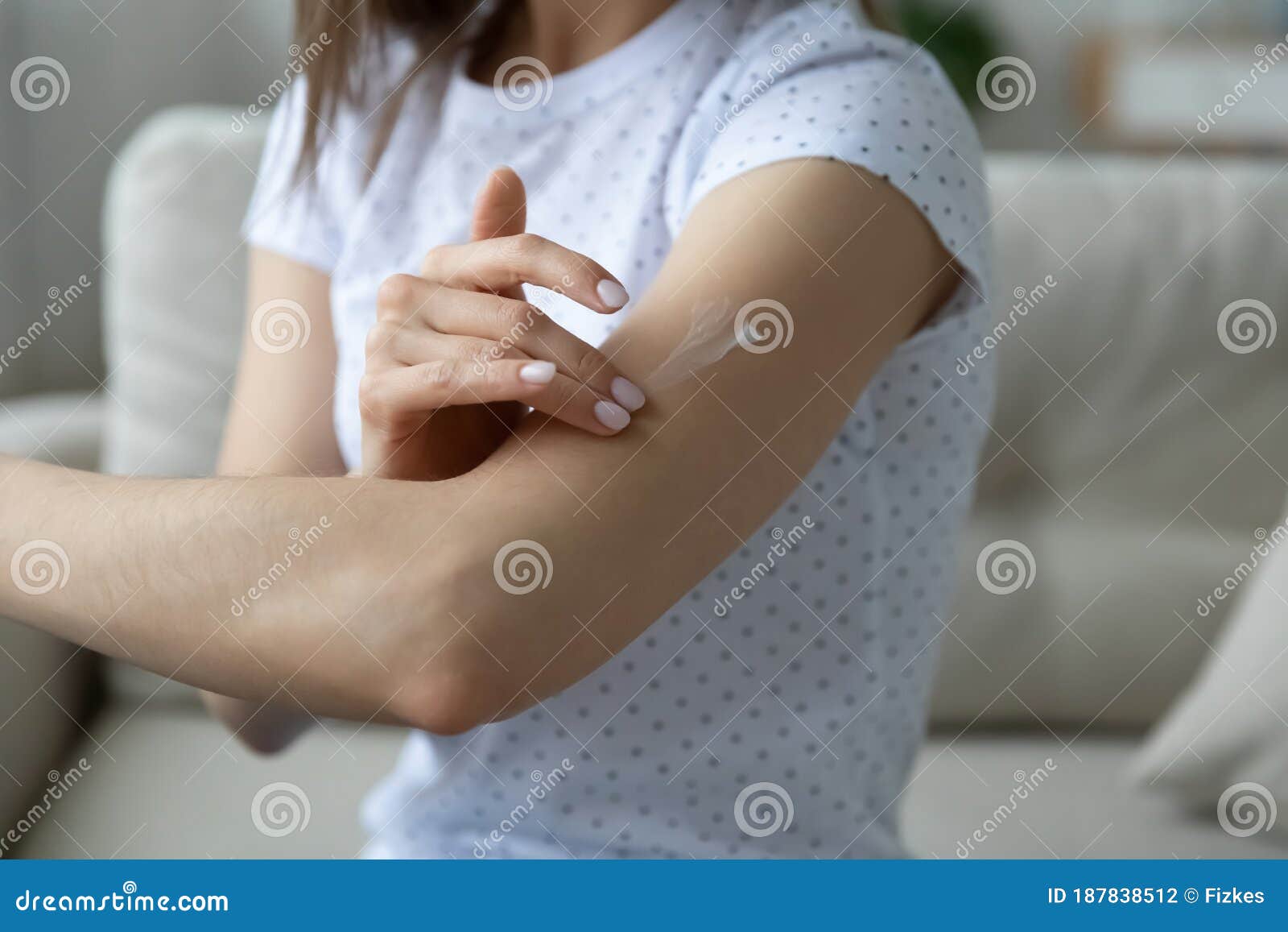 woman applying cream on arm using natural treatment closeup view
