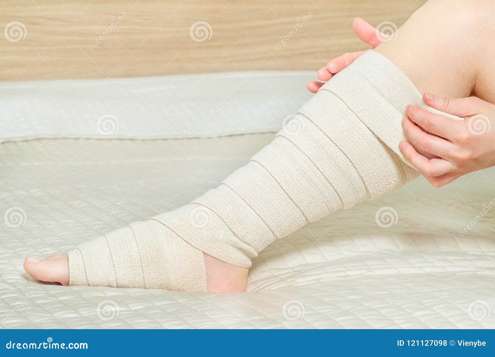 Woman Applying Elastic Compression Bandage As a Thrombosis Prevention