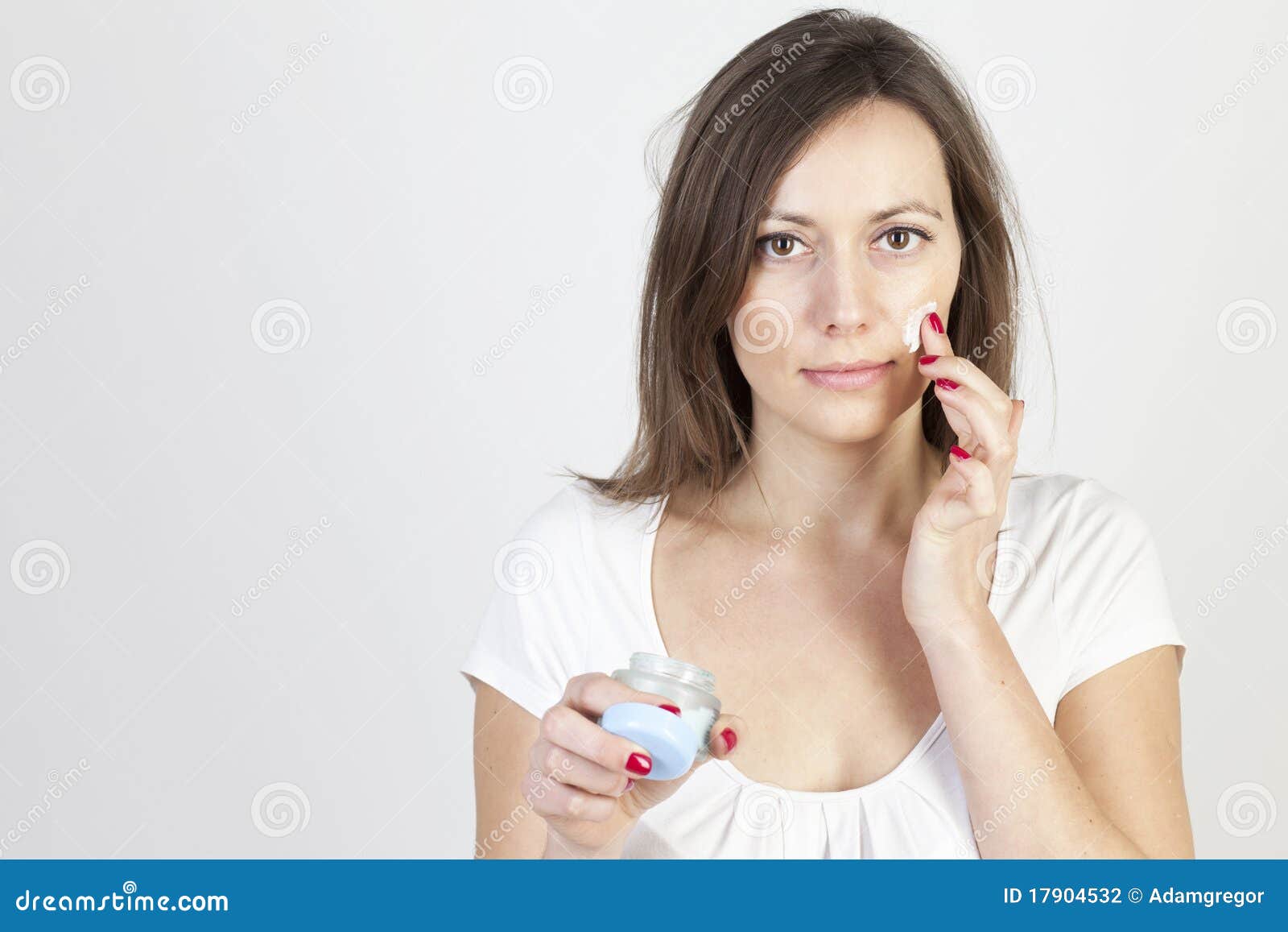 Woman applying lotion stock photo. Image of freshness 17904532
