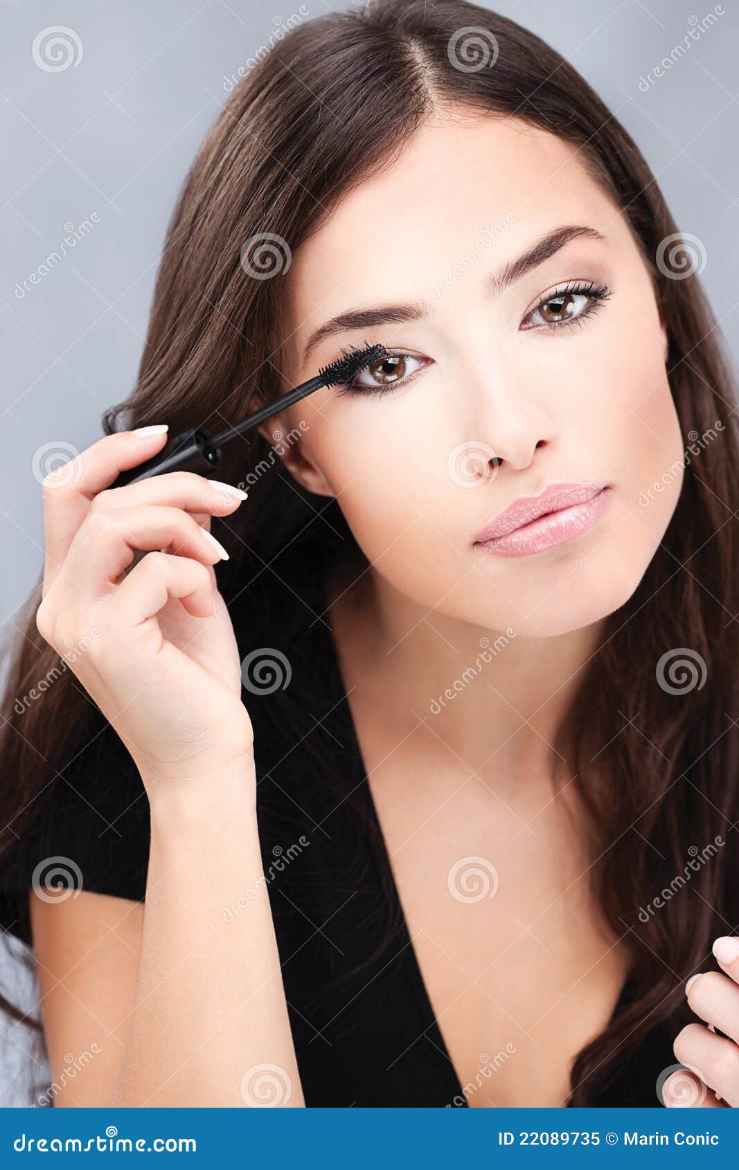 woman applying mascara