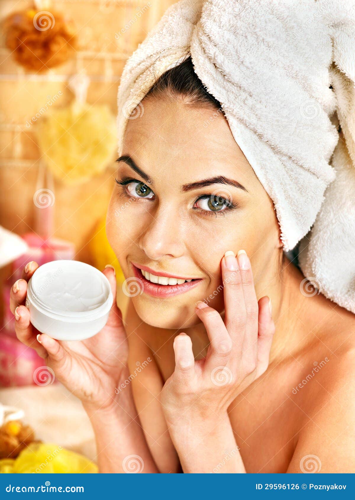 woman applying moisturizer.
