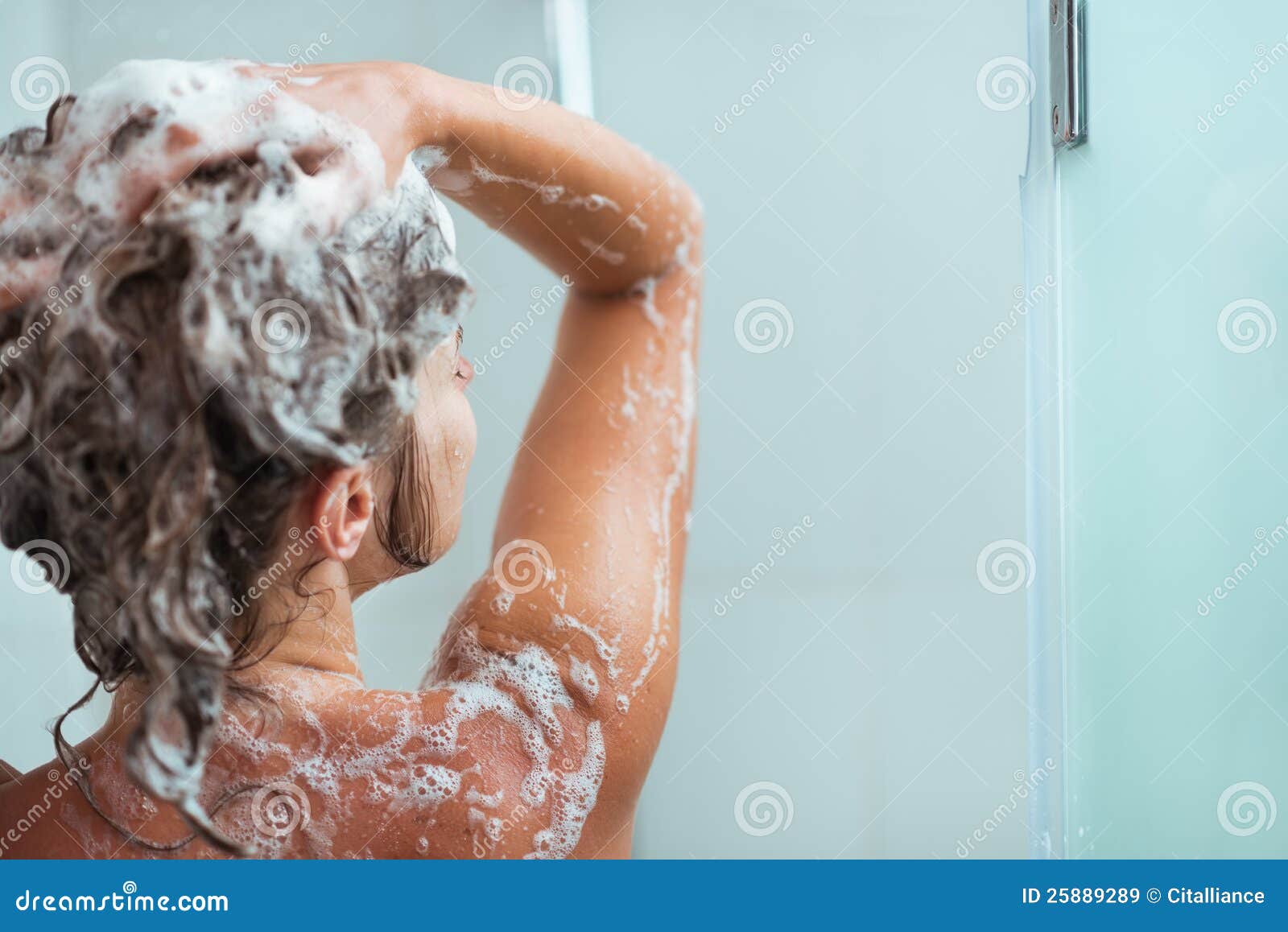woman applying shampoo in shower