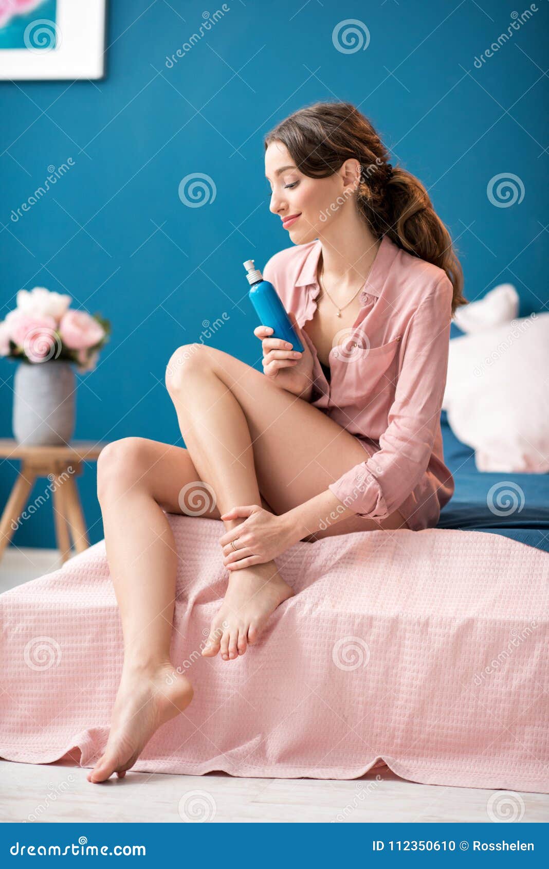 Pretty woman with a bottle between her legs Stock Photo