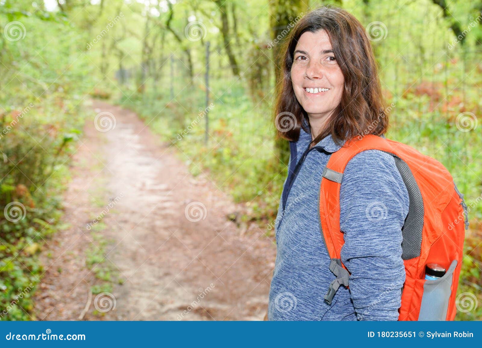 Woman with Backpack Walking in the Forest Pathway Stock Image - Image ...