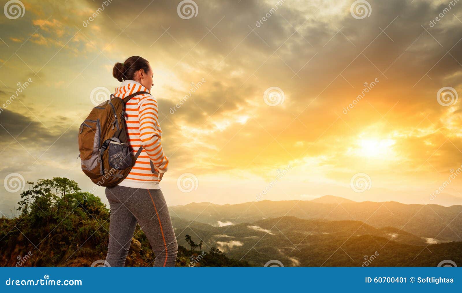 woman backpacker traveling with backpack standing on top of the