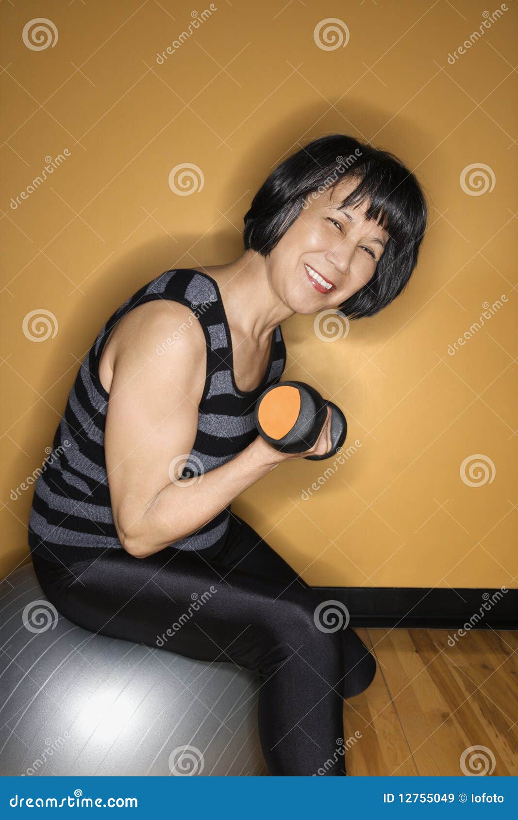 Woman on Balance Ball Lifting Weights Stock Image Image of copy