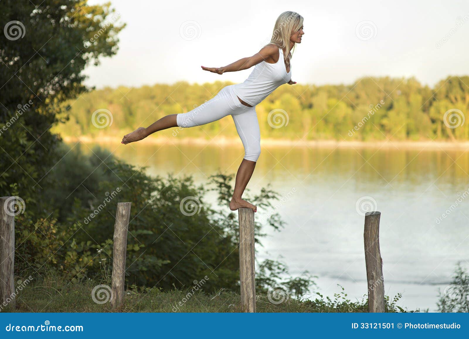 woman balancing beside river