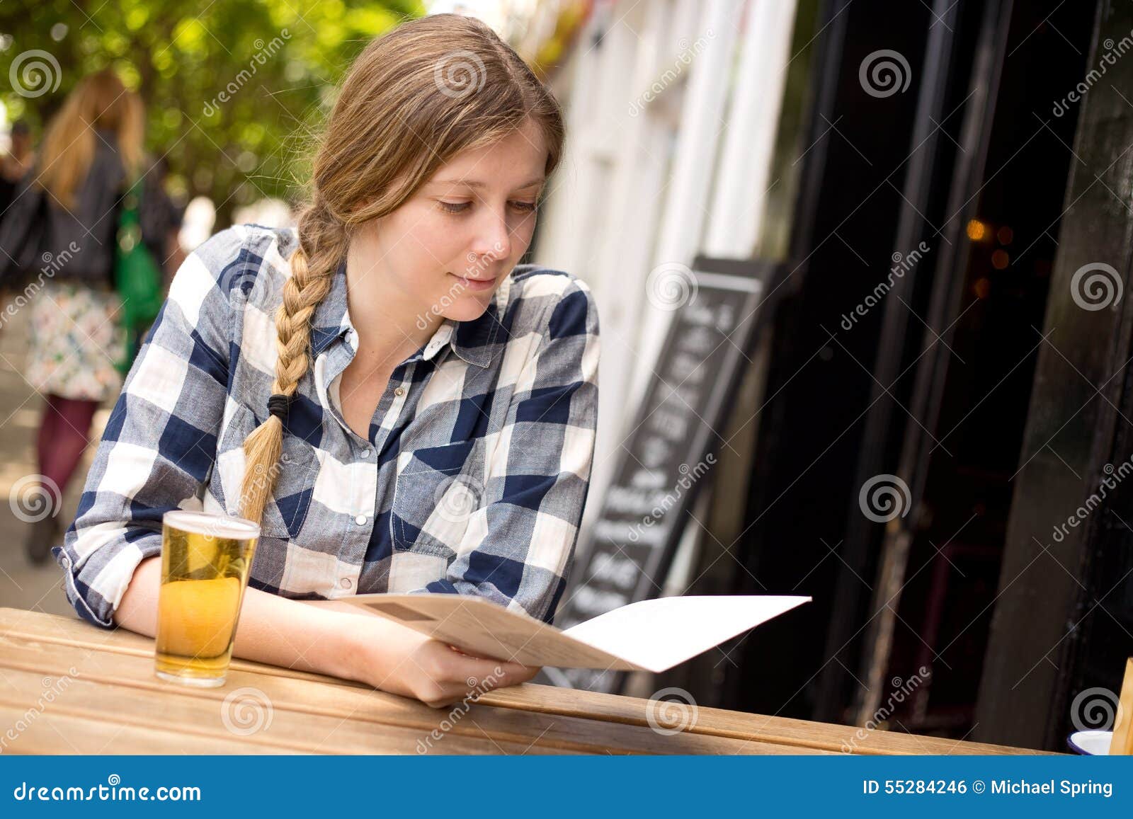 Woman at bar reading menu stock photo. Image of pleasure - 55284246