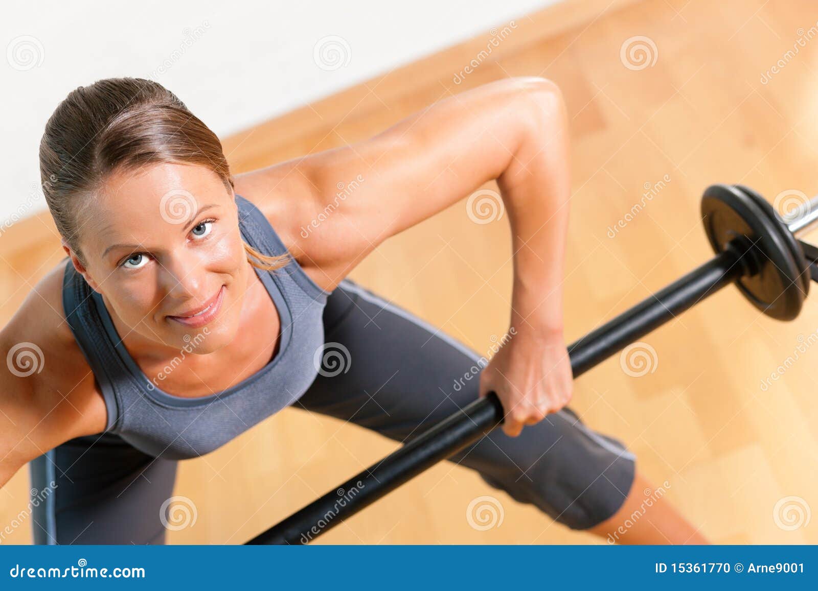 Woman with barbell in gym stock photo. Image of exercise 15361770