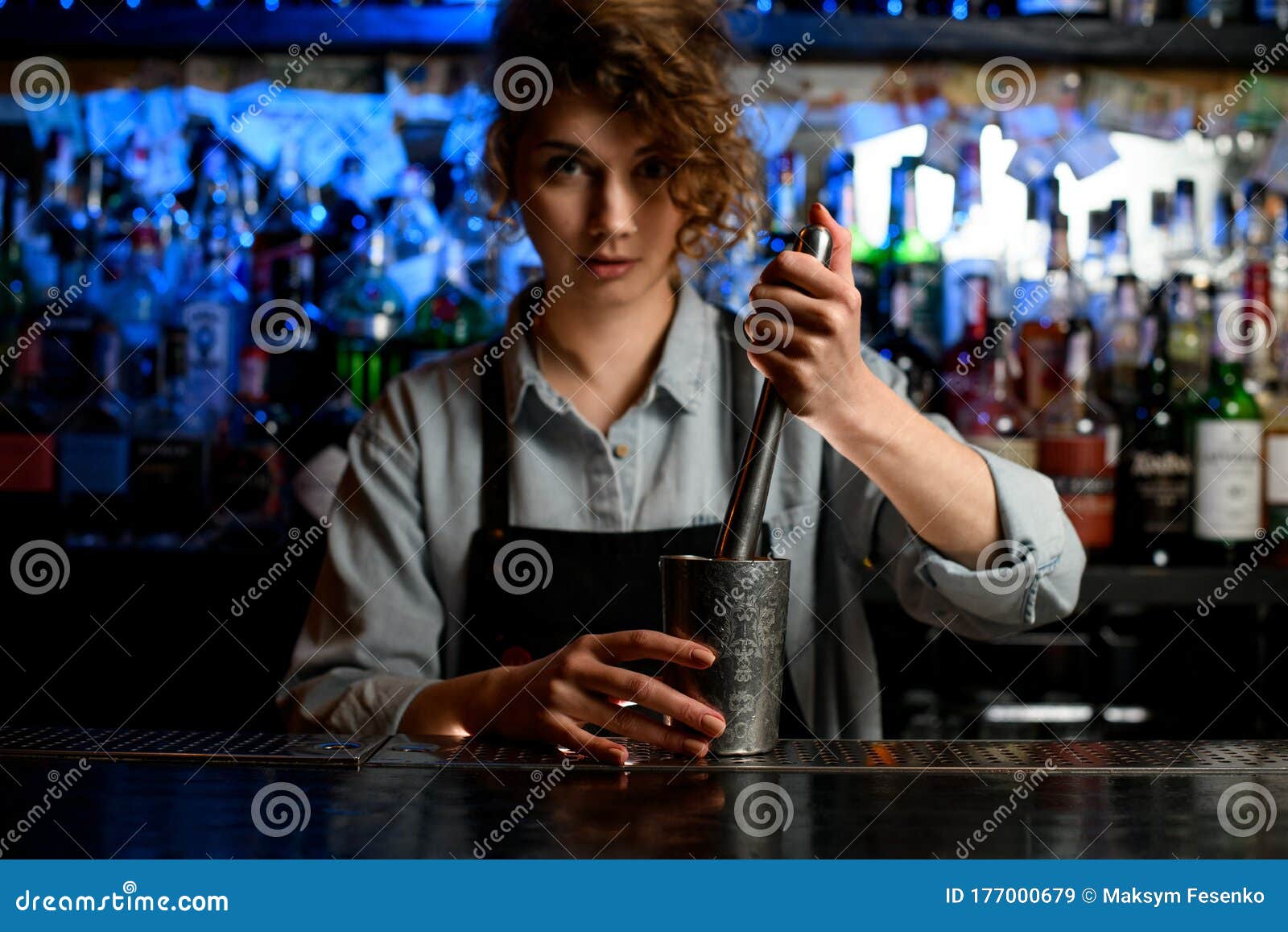 Woman Barman in Black Apron Holds Steel Glass and Metal Madler. Stock ...