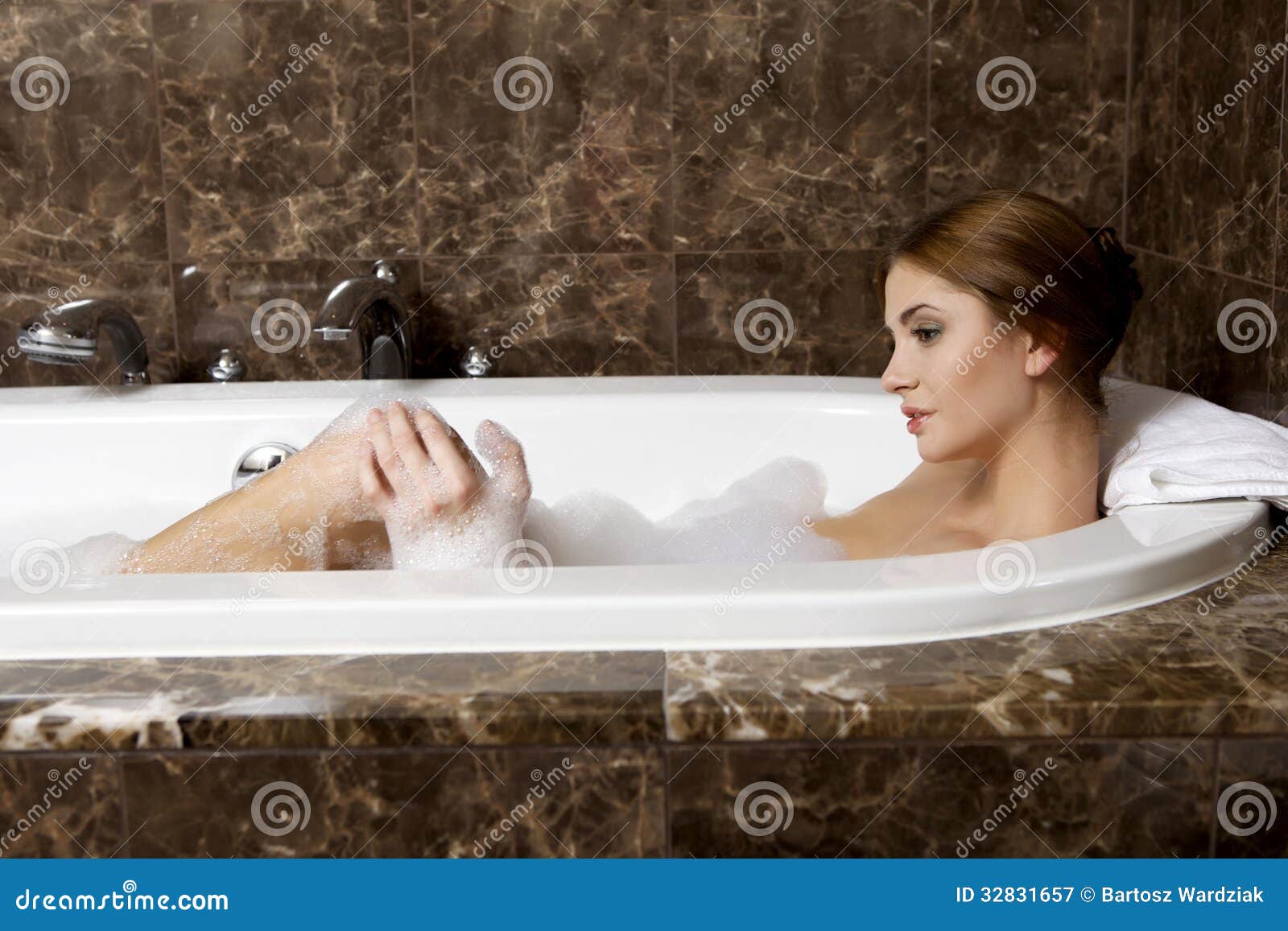 Teenager Girl Plunging The Clogged Bathtub Stock Photo - Download