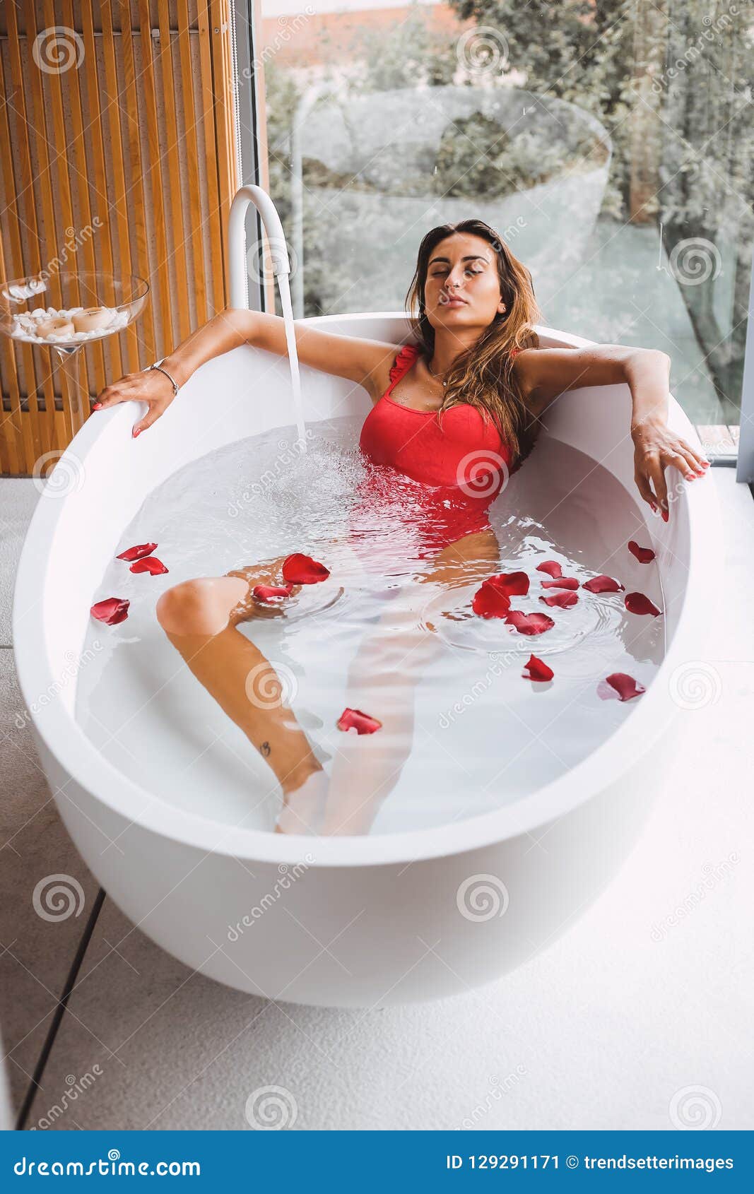 Woman in a modern bath tub stock image. Image of relaxation - 129291171