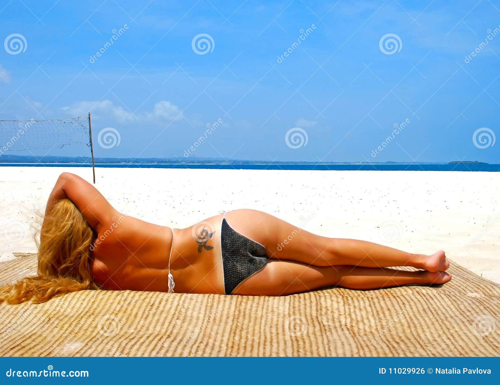 Woman on the beach. Girl taking sunbath, Zanzibar beach, Africa