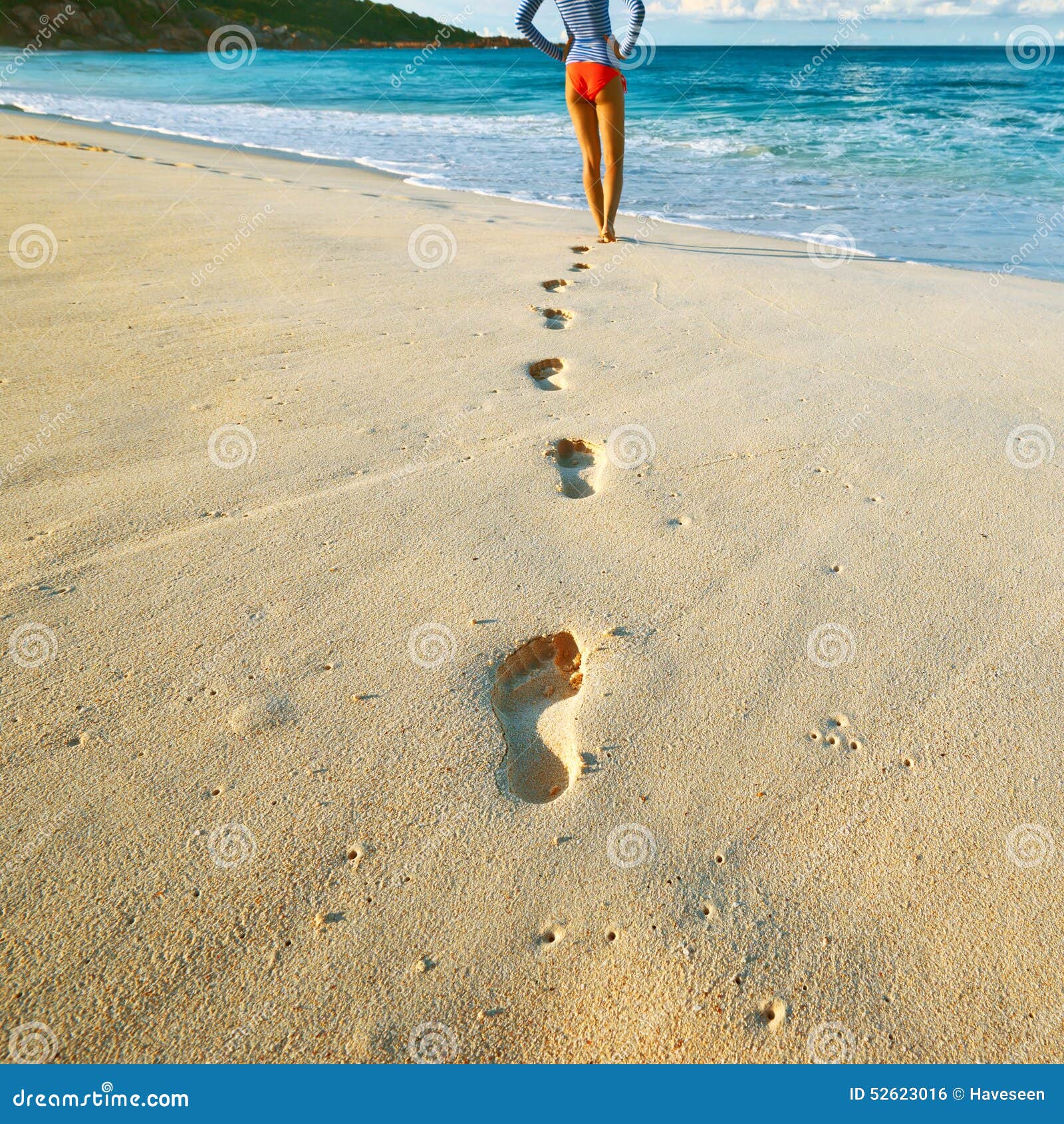 Woman at Beautiful Beach. Focus on Footprints. Stock Photo - Image