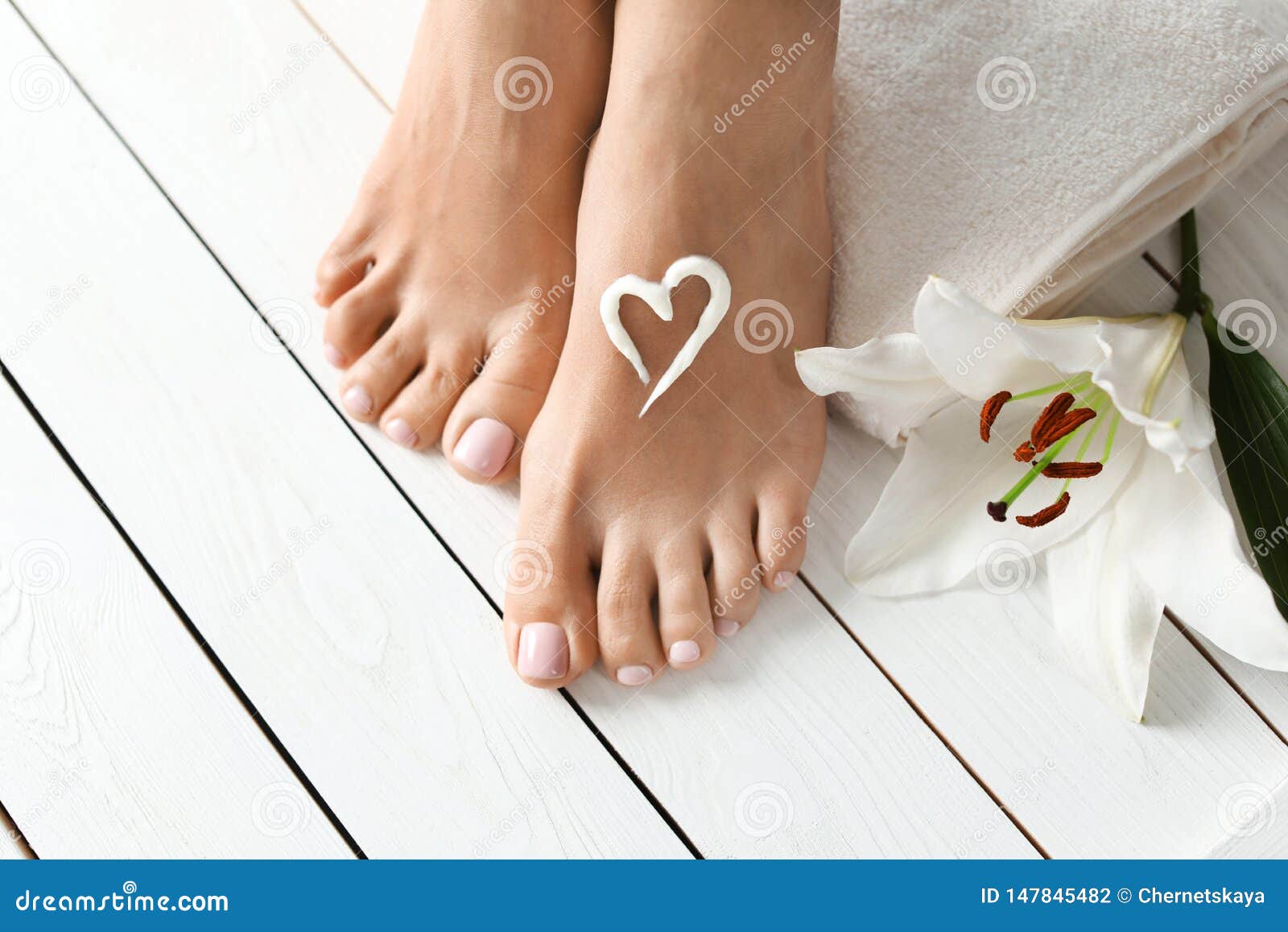 Woman with Beautiful Feet, Cream, Flower and Towel on White Wooden Floor,  Closeup. Stock Photo - Image of closeup, legs: 147845482
