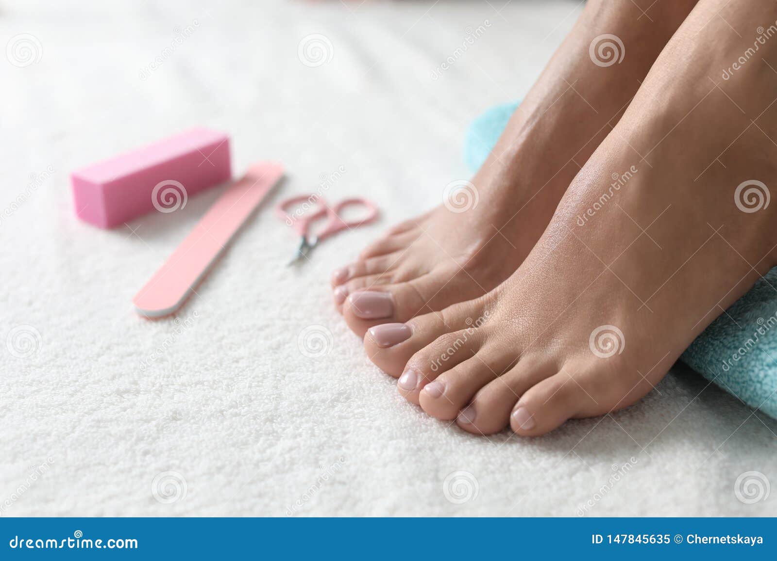 Woman with Beautiful Feet and Pedicure Accessories on White Towel ...