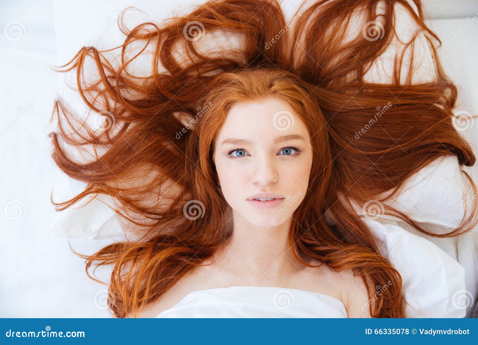 Woman With Beautiful Long Red Hair Lying In Bed Stock