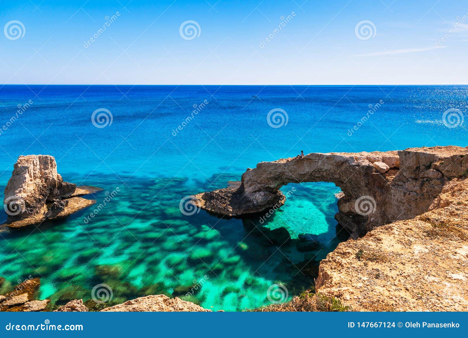 woman on the beautiful natural rock arch near of ayia napa, cavo greco and protaras on cyprus island, mediterranean sea. legendary