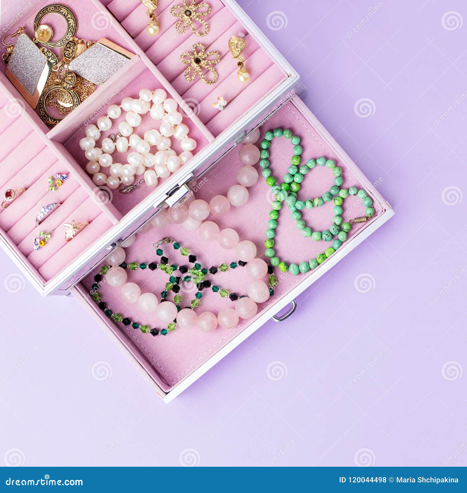 Open Jewelry Box with Neclaces, Earrings and Rings on Pastel Background ...