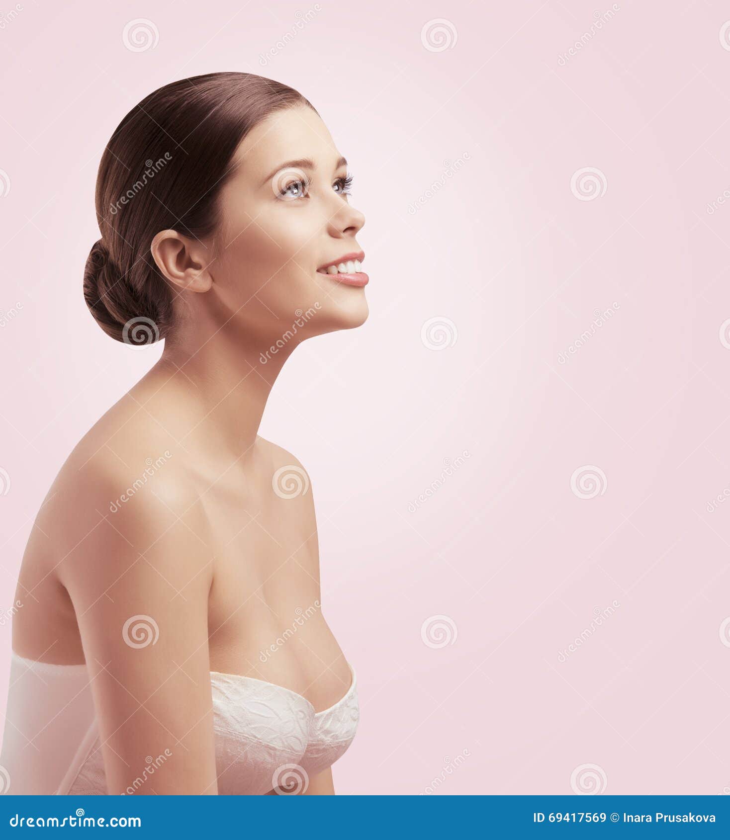Young nude woman with covered breast touching face. Skin pampering concept.  Stock Photo