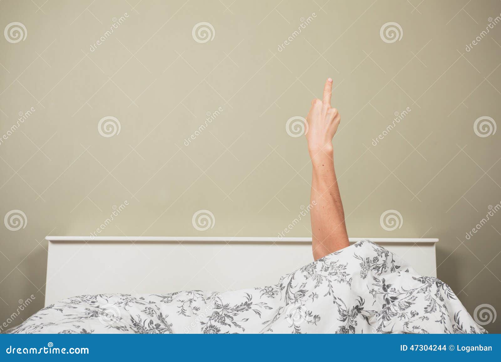 woman in bed displaying obscene gesture