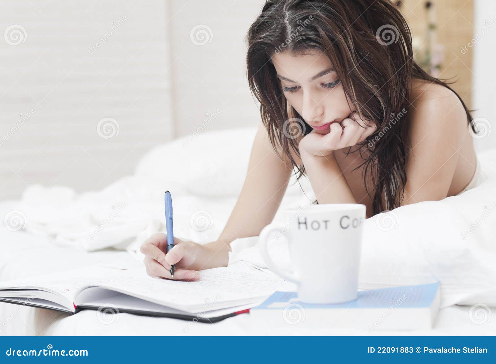 woman bed writing notebook 22091883