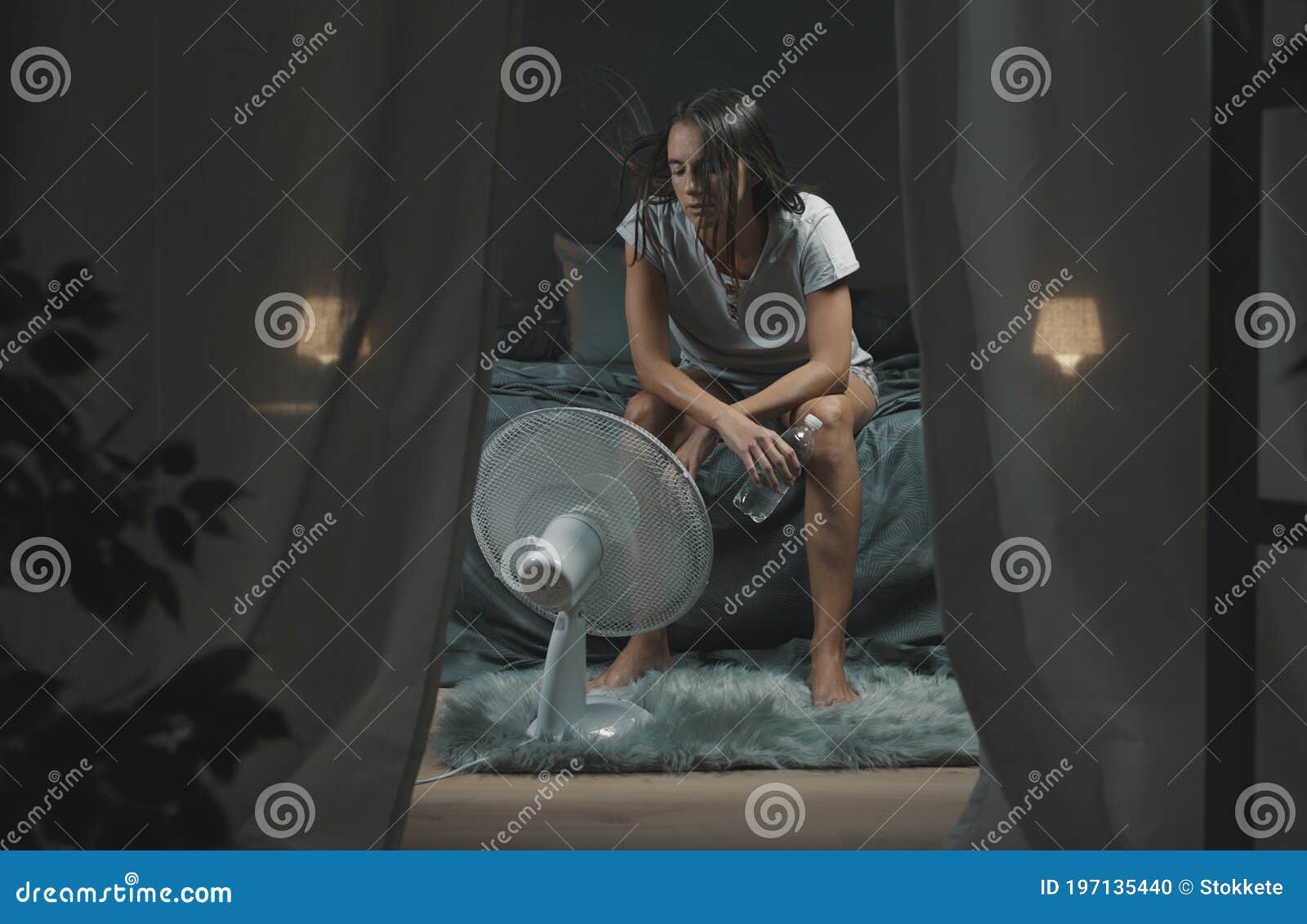 woman in bedroom suffering during a heatwave