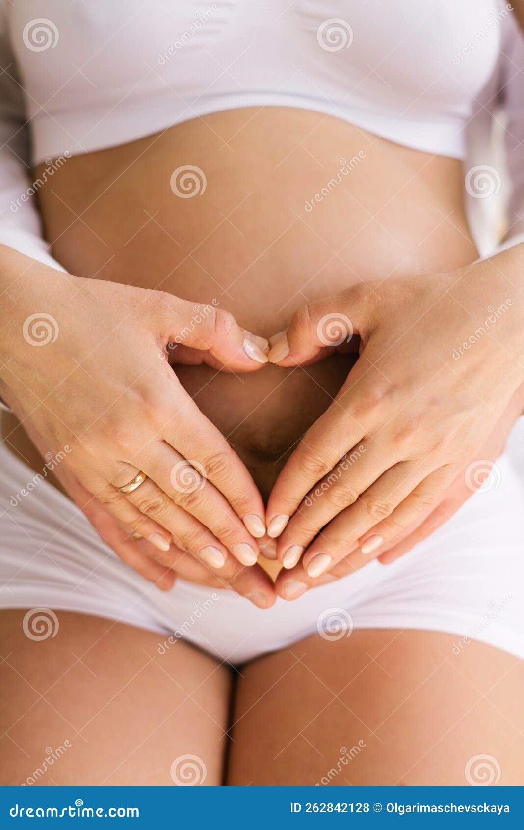 Woman with a Big Bare Tummy is Sitting on a Bed in Her Underwear with a  Bare Stomach. a Pregnant Lady and Her Husband Hold Their Stock Photo -  Image of contemplation