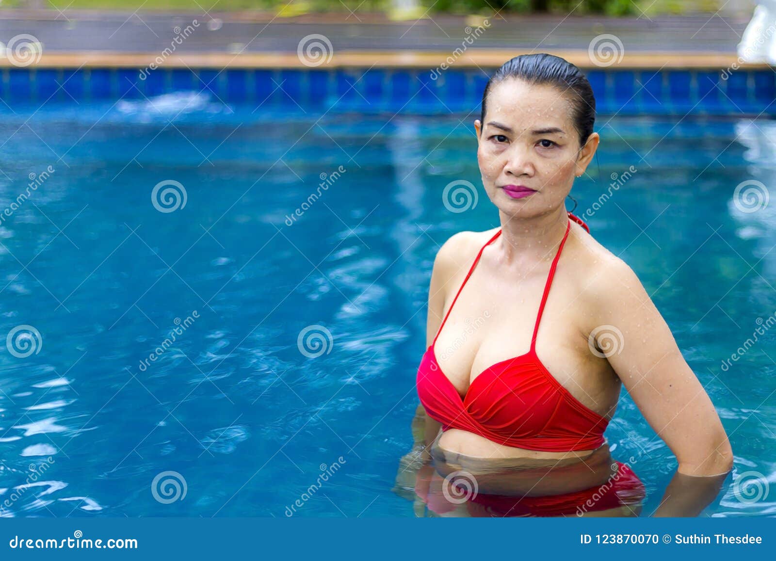 Woman Big Breast Sex Symbol with Red Bikini at Swimming Pool Stock Photo pic