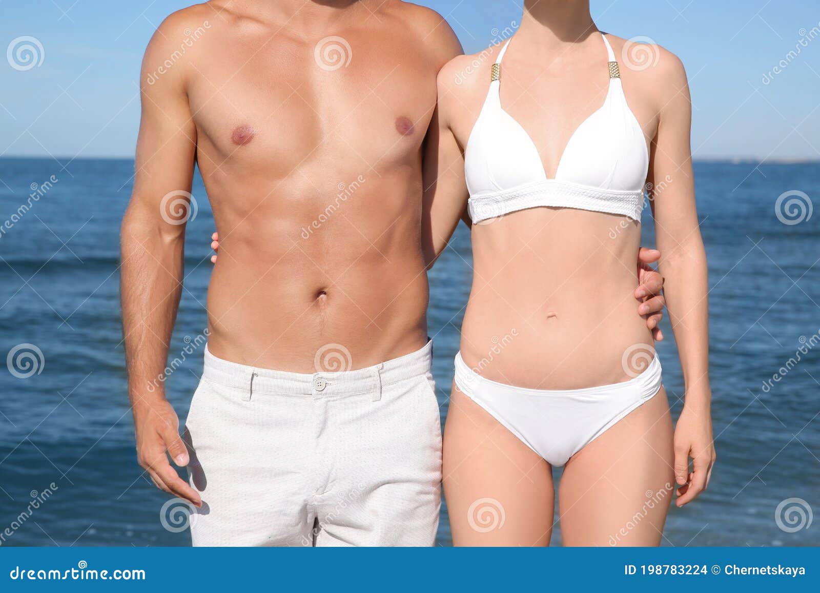 Woman in Bikini and Her Boyfriend on Beach, Closeup