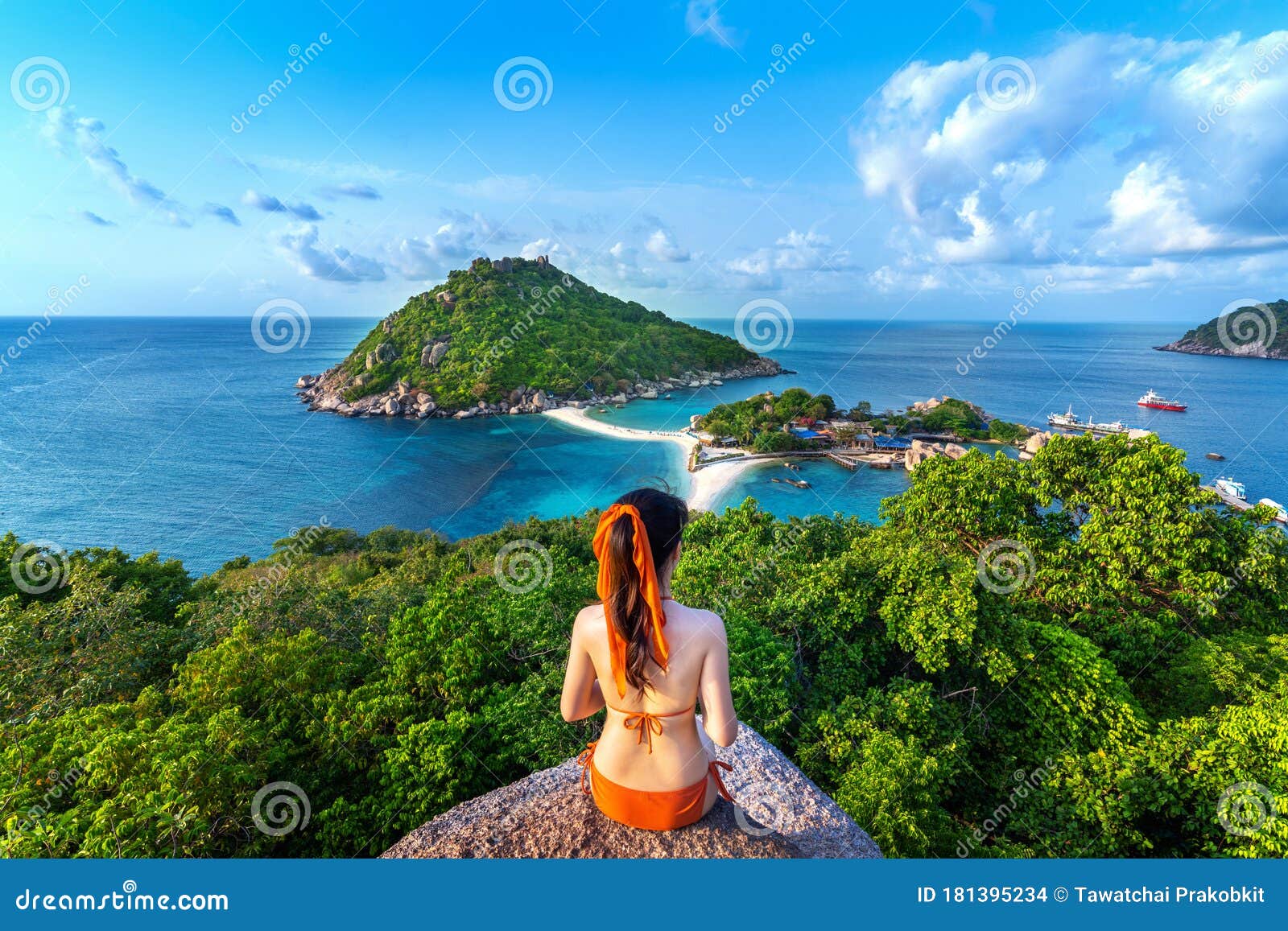 woman in bikini sitting at the viewpoint of nang yuan island, thailand