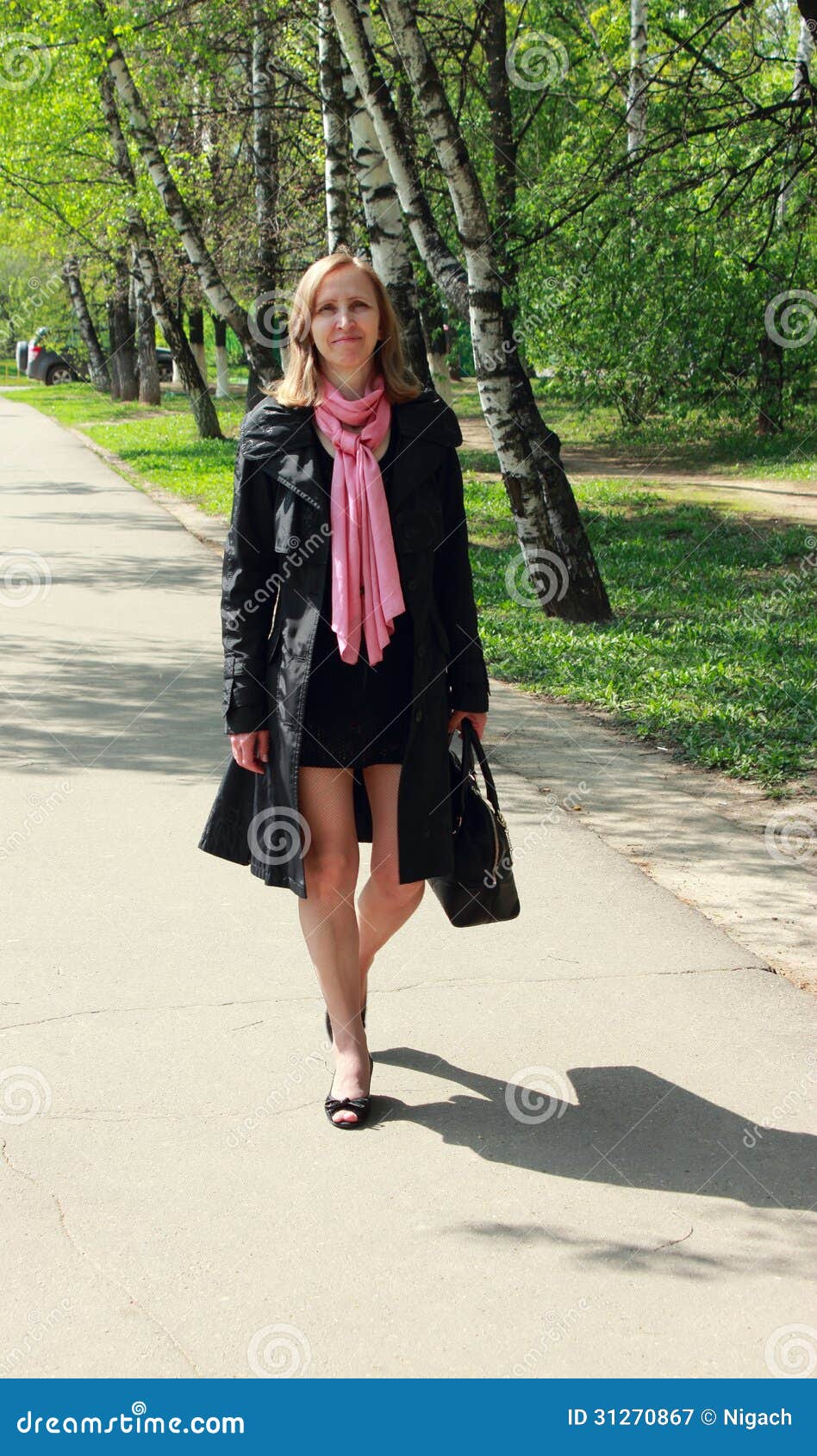 A woman in a black cloak stock image. Image of grass - 31270867