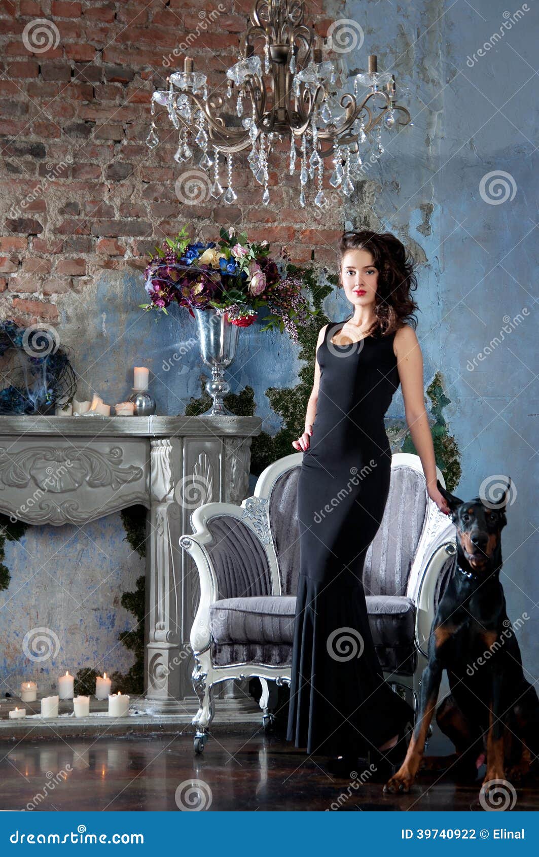 Woman In Black Long Dress Sitting On Chair With Dog 