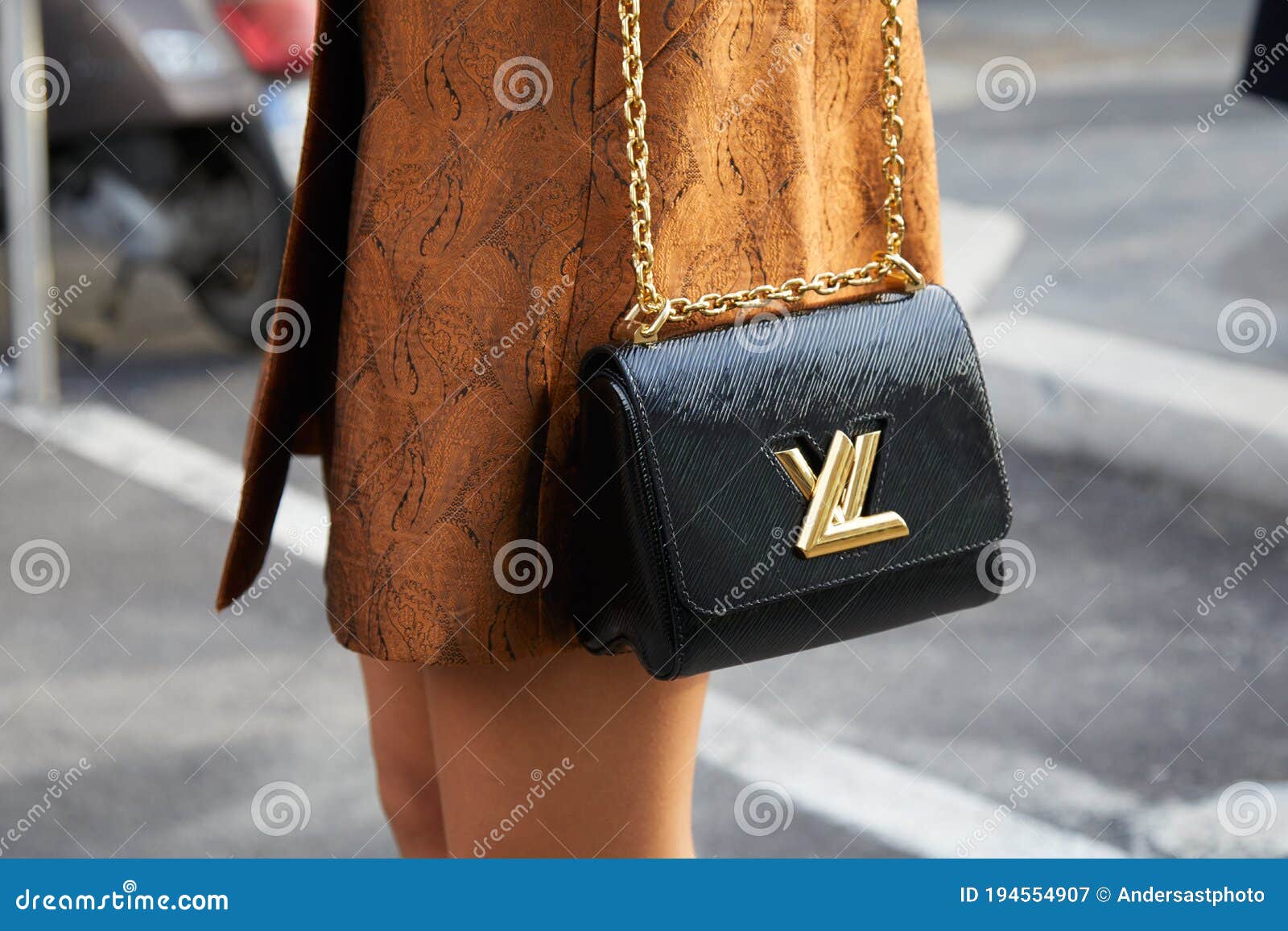 Woman with Black Louis Vuitton Bag with Golden Logo and Brown