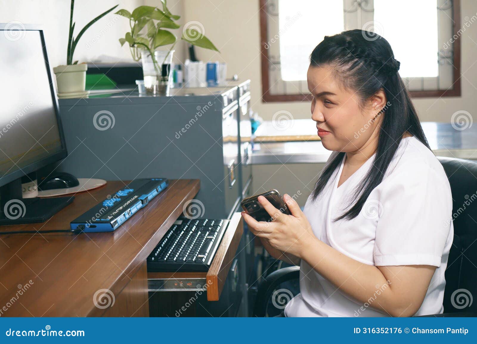 woman with blindness disability using smart phone with voice accessibility for persons with disabilities in workplace with