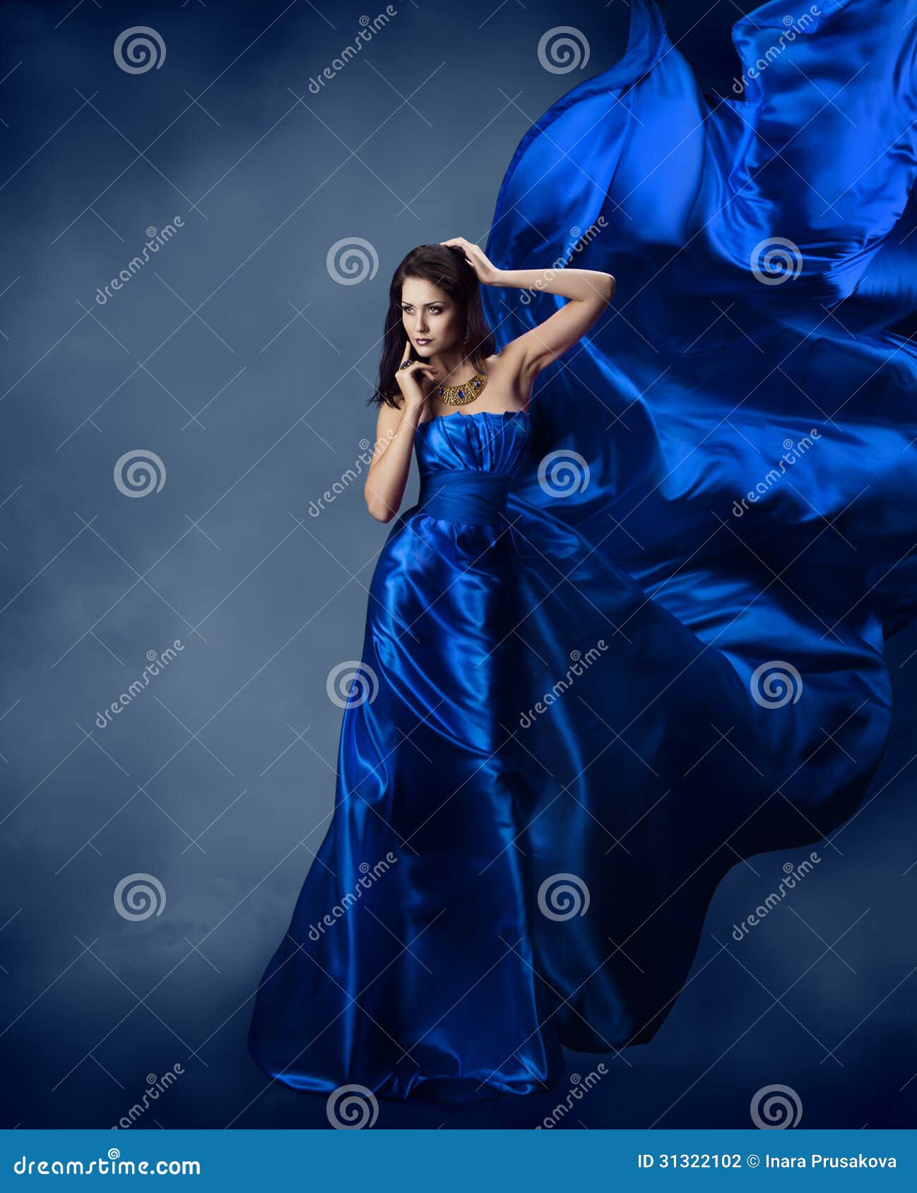 woman in blue dress with flying silk fabric