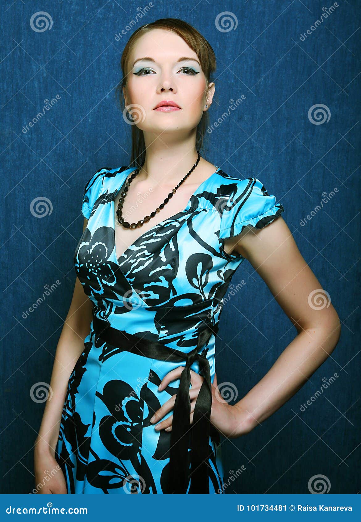 Woman in a Blue Dress Posing on a Blue Background Stock Image Image