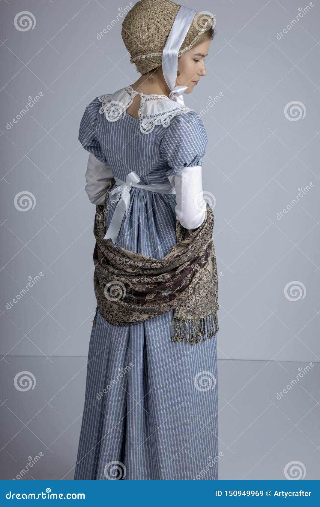 regency woman in blue striped dress on plain background
