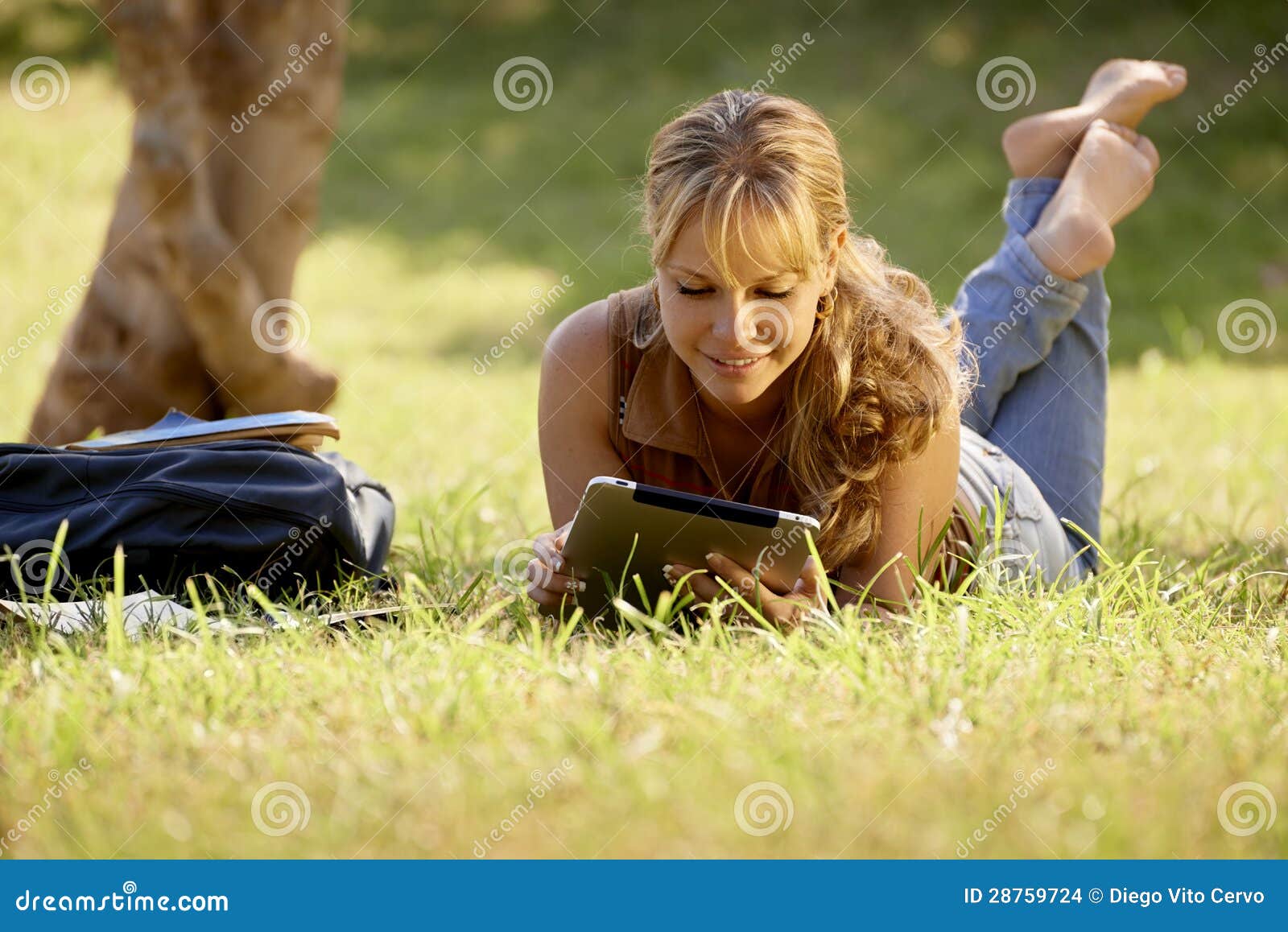 woman with books and ipad studying for college test