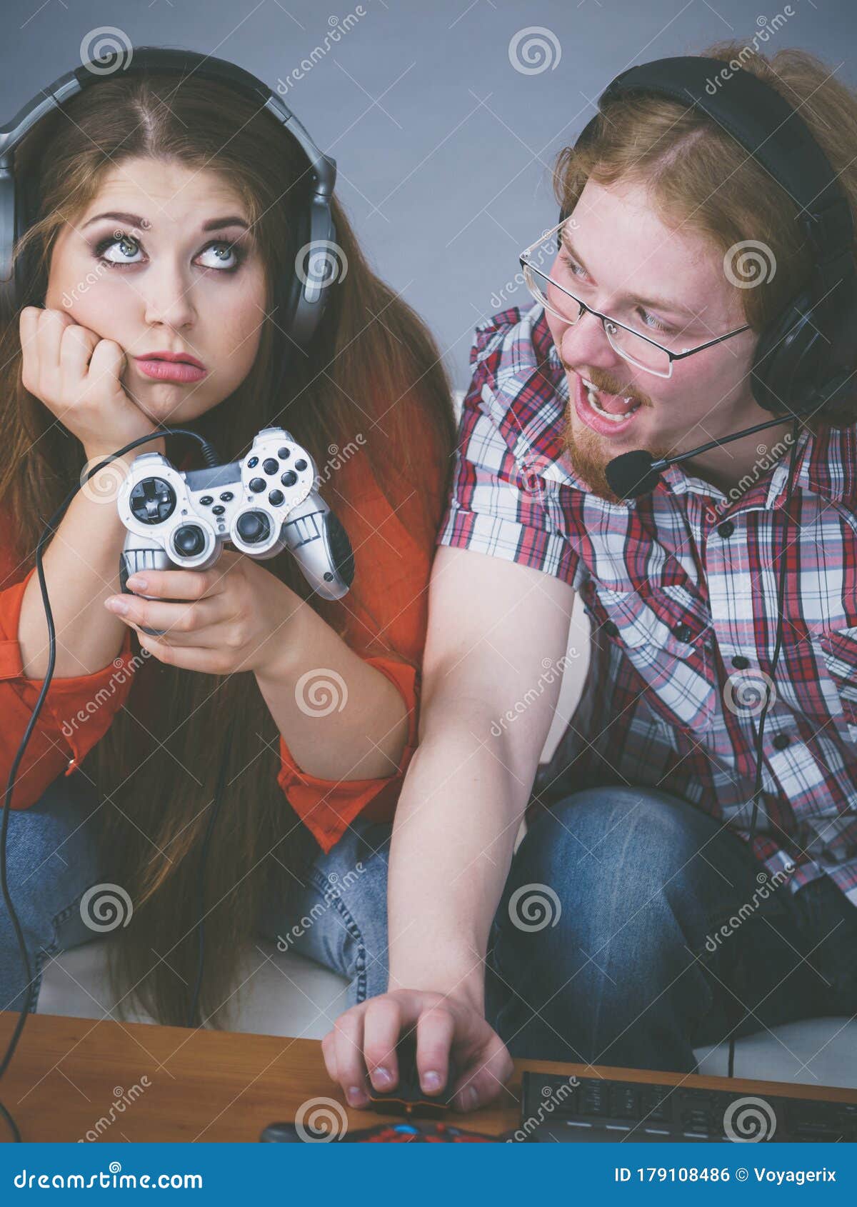 Man Playing Video Games At Home And His Girlfriend Bored Beside Looking At  Him Stock Photo, Picture and Royalty Free Image. Image 52407663.