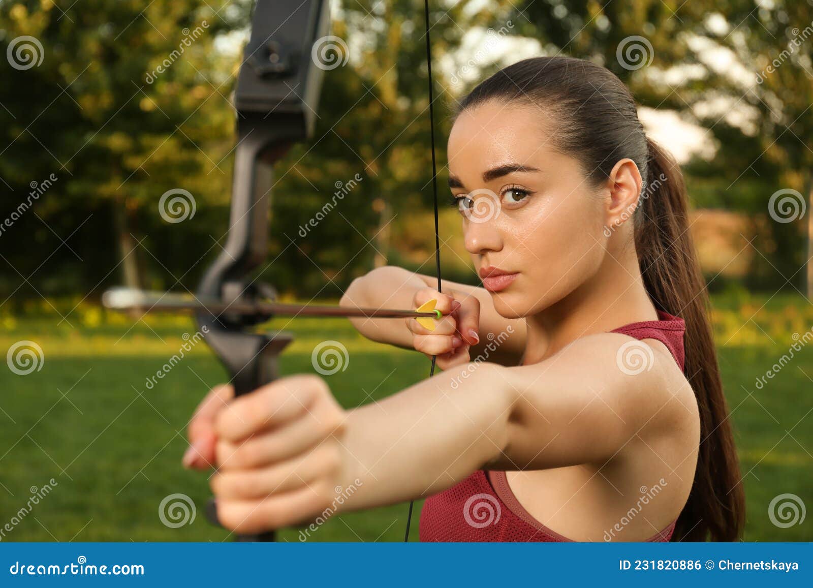 Woman with Bow and Arrow Practicing Archery in Park Stock Photo Image