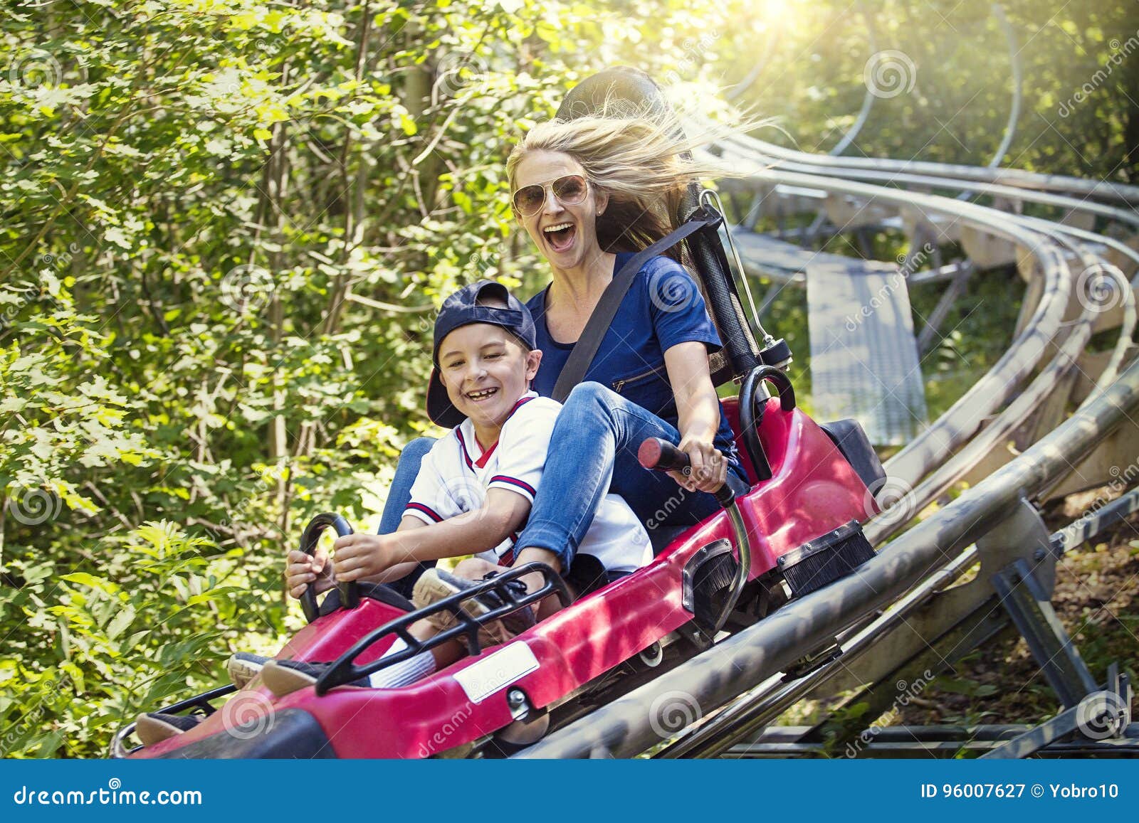 woman and boy enjoying a summer fun roller coaster ride