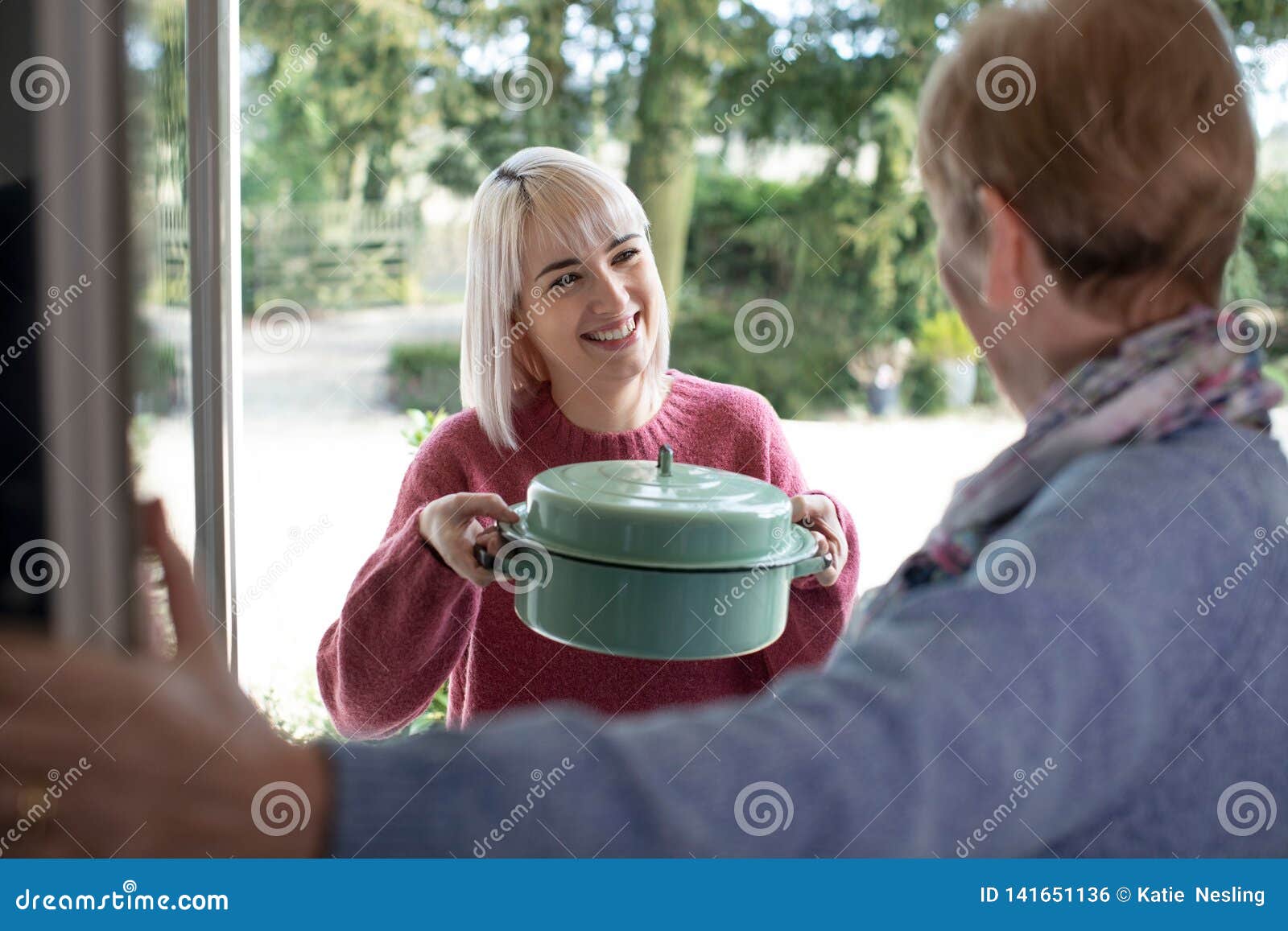 woman bringing meal for elderly neighbour