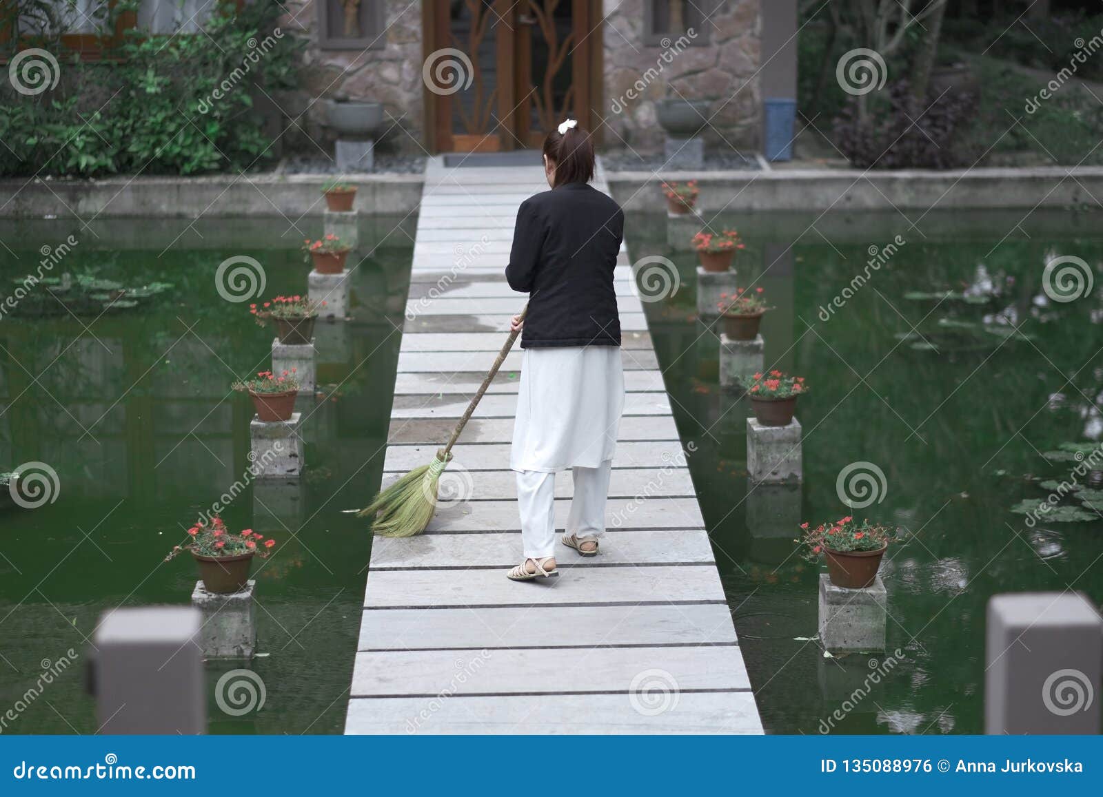 woman brings cleanness on wooden walkway